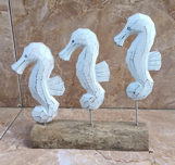 Bring the charm of the ocean into your home with this unique Seahorse Display featuring three intricately crafted seahorses on a rustic driftwood-style base. Perfect for adding a coastal