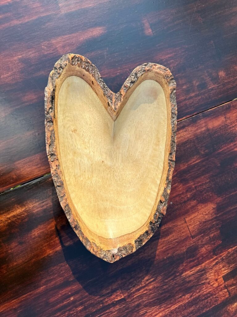 Add a touch of rustic elegance to your home with this heart-shaped wooden tray