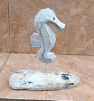 Add a touch of coastal charm to your decor with this Seahorse Sculpture on a rustic driftwood-style base. Crafted with an artisanal flair